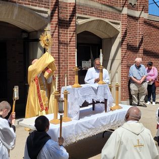 Fr. Andrew holding the Eucharist